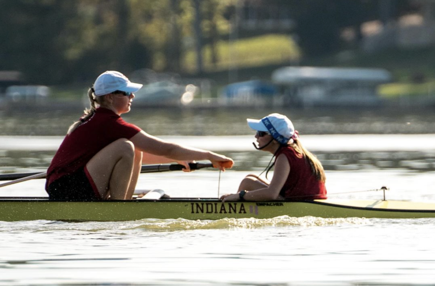 Two IU students on the rowing team are photographed on the water during a practice. 